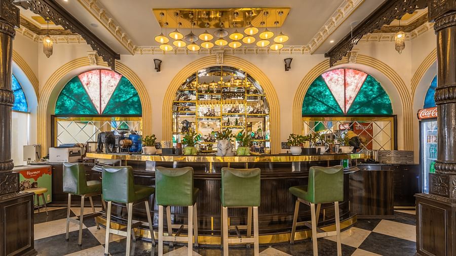 an image of the the bar counter with with glass windows in the wall and hanging lights